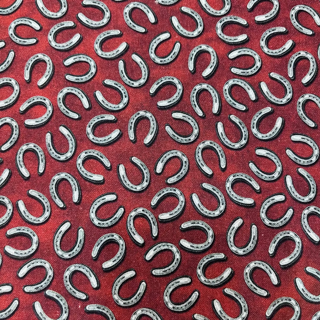 Pattern of silver horseshoes on a red background