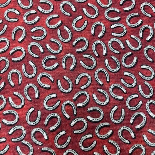 Pattern of silver horseshoes on a red background