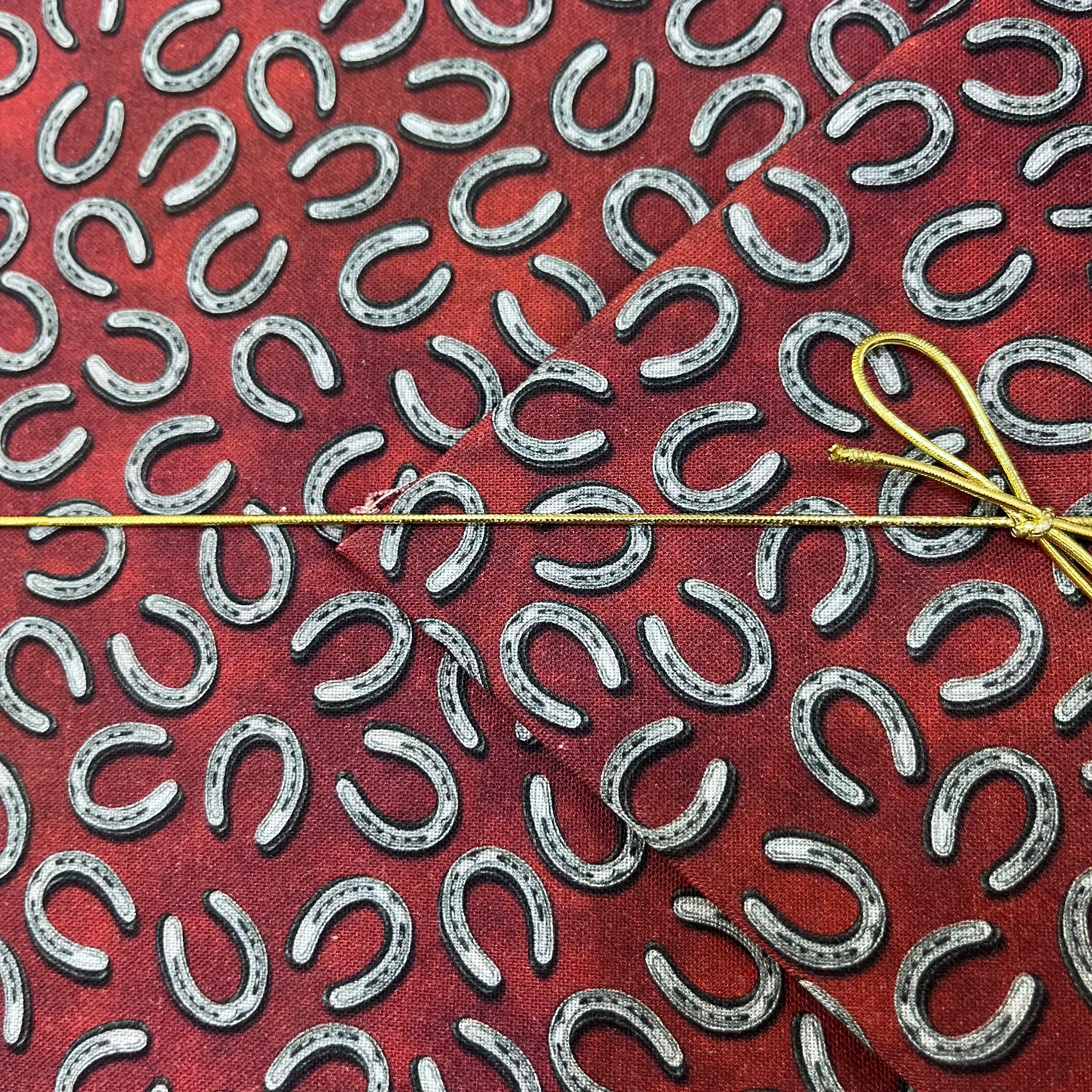 Benartex - Yellowstone - Tossed Horseshoes Brick Red Fabric